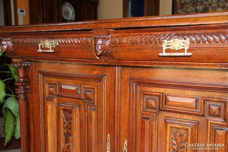 A tin German, richly carved chest of drawers