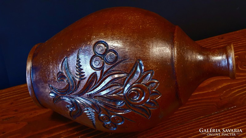 Old, brown, engraved, large ceramic jug or vase.