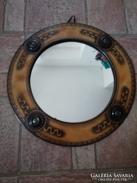 Mirror with leather decoration