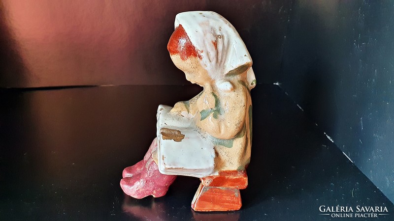 Antique sitting reading girl, porcelain figure.