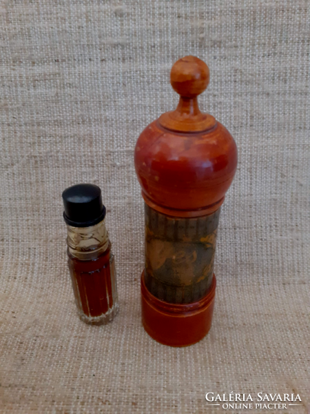 A polished glass jar with perfume essence in an antique wooden jar.
