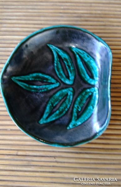 Ceramic ashtray and bowl with green leaves on a black, somewhat iridescent background, in a special shape of retro industrial art