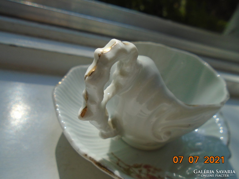 Antique ribbed embossed shell cup with saucer and laced tongs