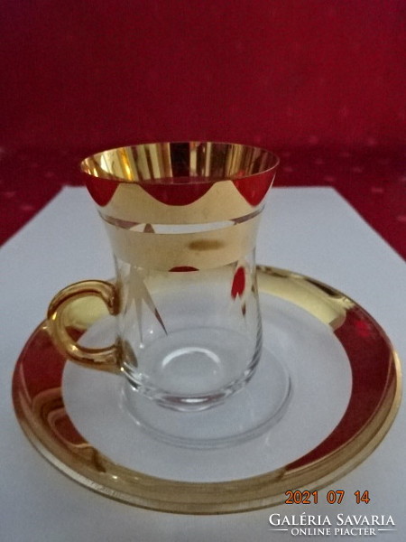 Glass tea cup with golden rim + saucer. He has!
