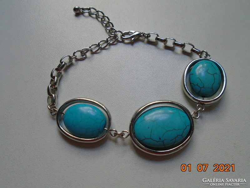 3 large polished bracelets with a turquoise stone that can be rotated on the axis, enclosed in a silver-plated frame