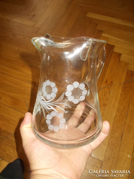 Old blown glass decorative jug with a polished floral pattern