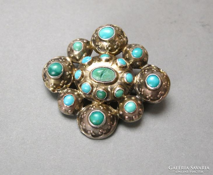 Old silver brooch with lots of turquoise.