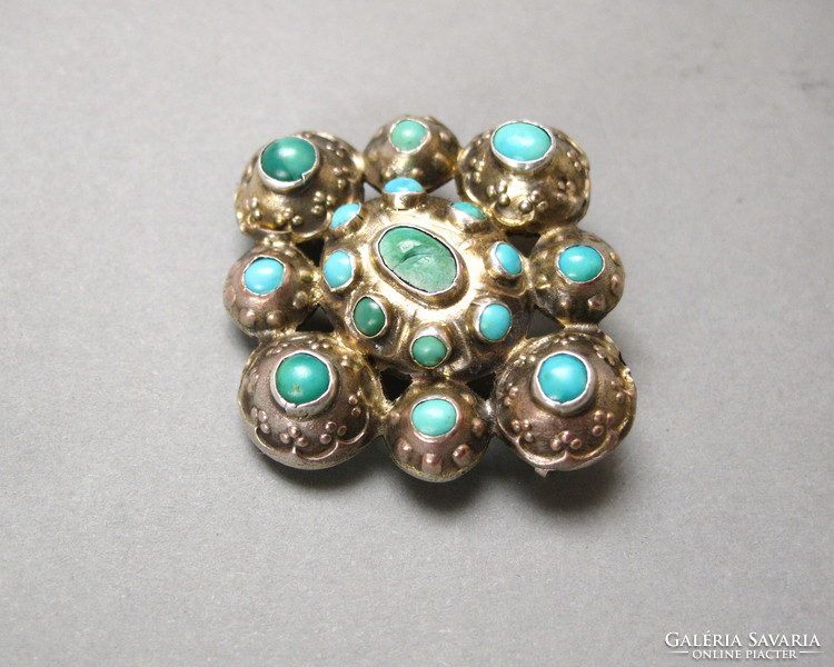 Old silver brooch with lots of turquoise.