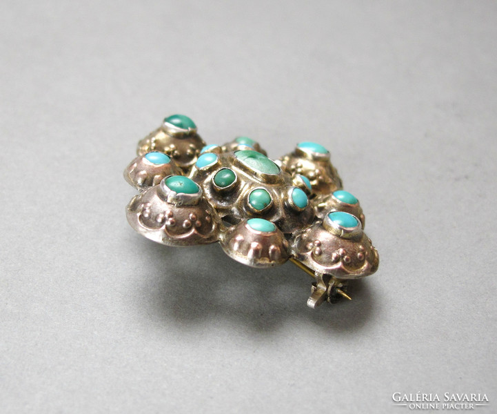 Old silver brooch with lots of turquoise.