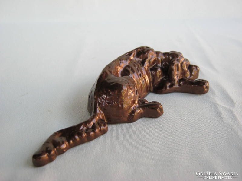 Reclining dog metal sculpture