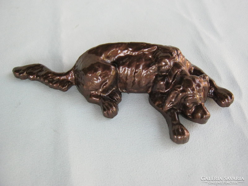 Reclining dog metal sculpture