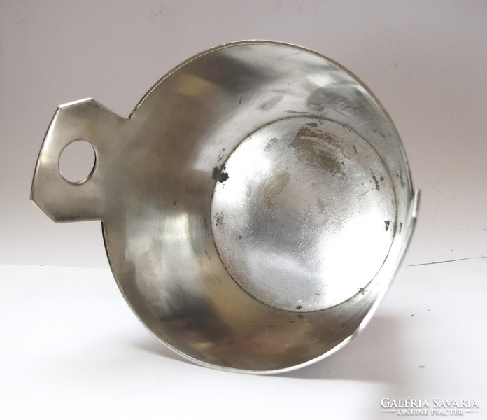 Showy, silver-plated, pot-shaped holder.