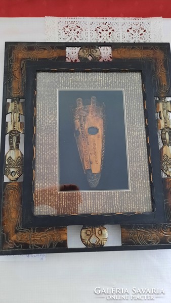 African mask made of copper, under glass, in a hand-carved frame. He has!