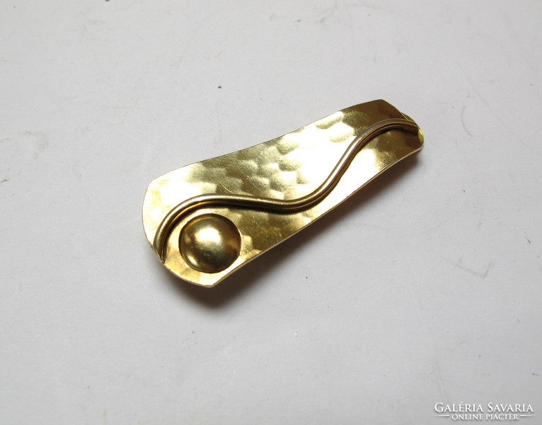 Gilded silver tie clip.