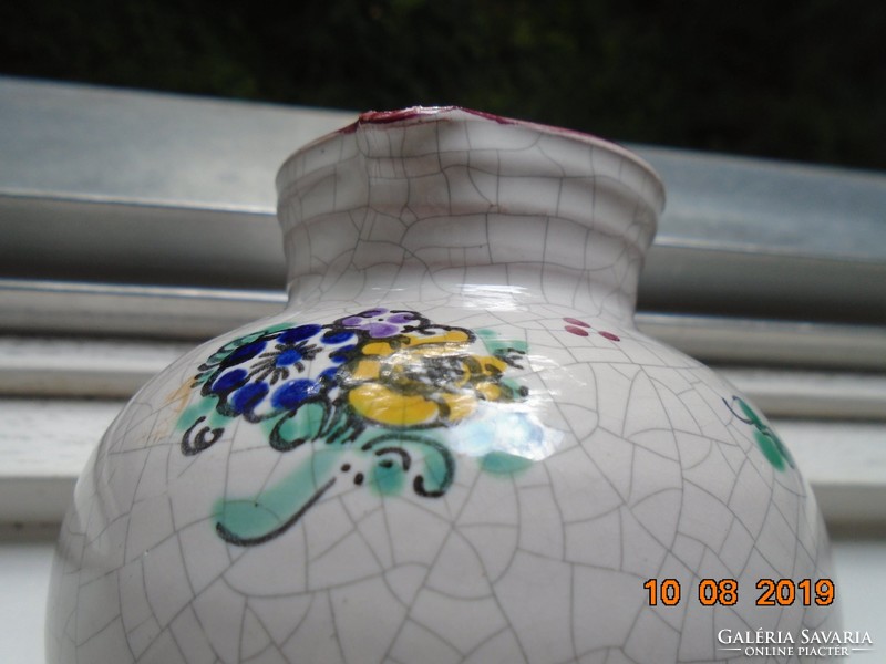 Signed majolica jug with hand-painted floral pattern and cracked glaze