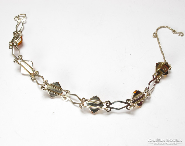 Silver bracelet with amber stones. Fischlandschmuck company.