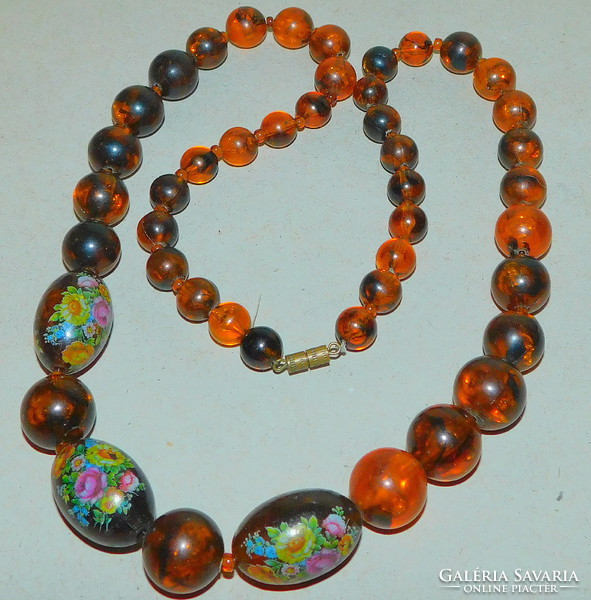 Vintage amber effect old pearl necklace with romantic bouquet of flowers