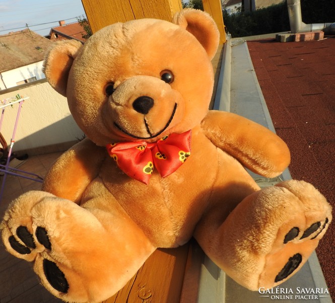 Huge teddy bear with teddy bear and bow tie