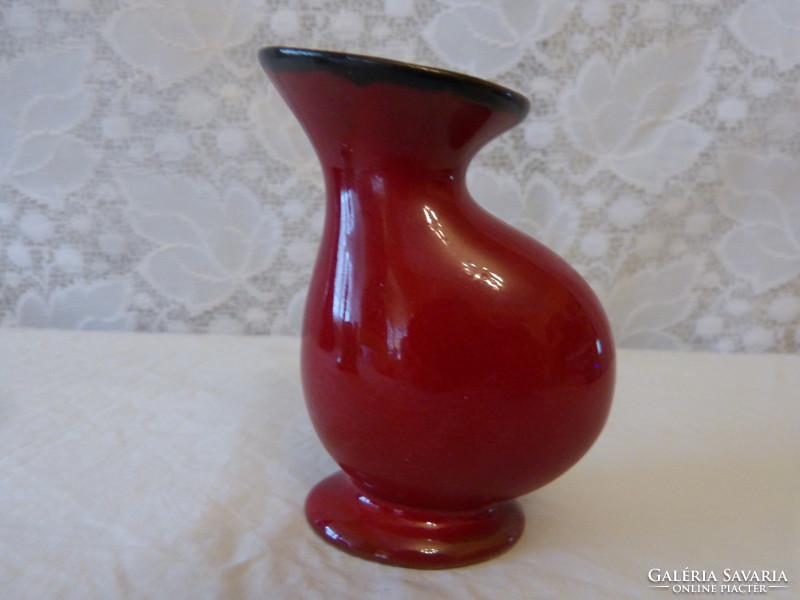 Red glazed mini vase.