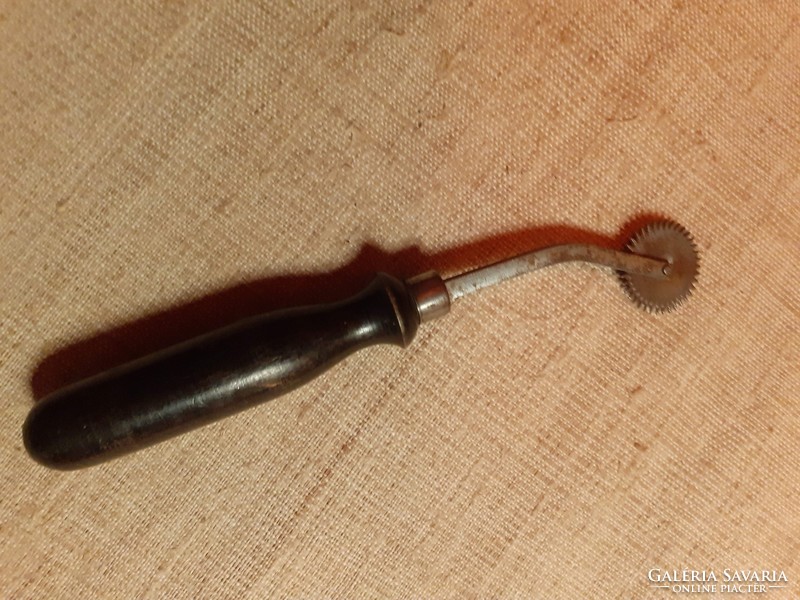 Old radli with black wooden handle