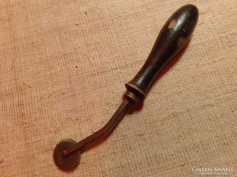 Old radli with black wooden handle