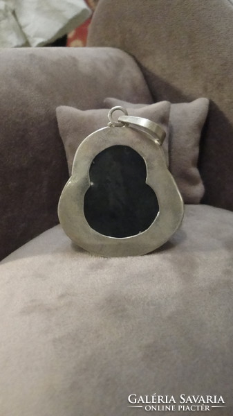 Silver pendant with nephrite stone carving