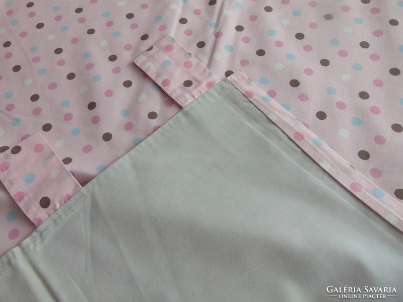 Lined curtains in pairs on a pink background with polka dots