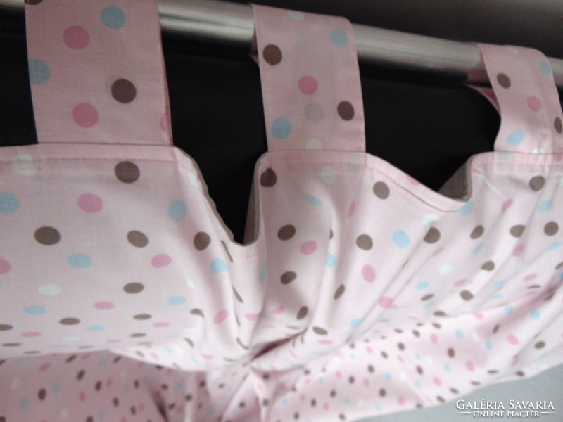 Lined curtains in pairs on a pink background with polka dots