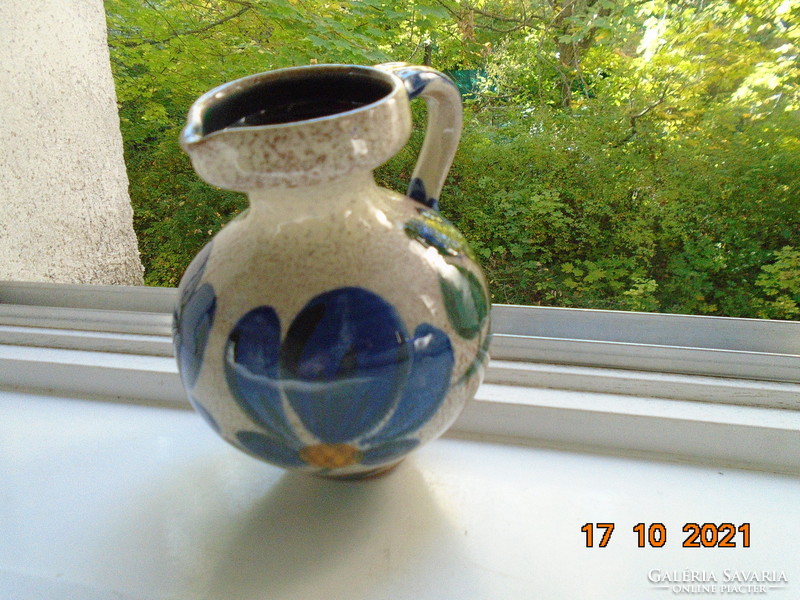Shaped, hand-painted floral. With a thick glaze that also shines on the inside, marked ceramic jug.