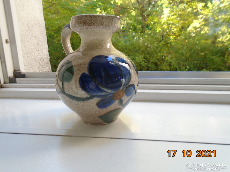 Shaped, hand-painted floral. With a thick glaze that also shines on the inside, marked ceramic jug.