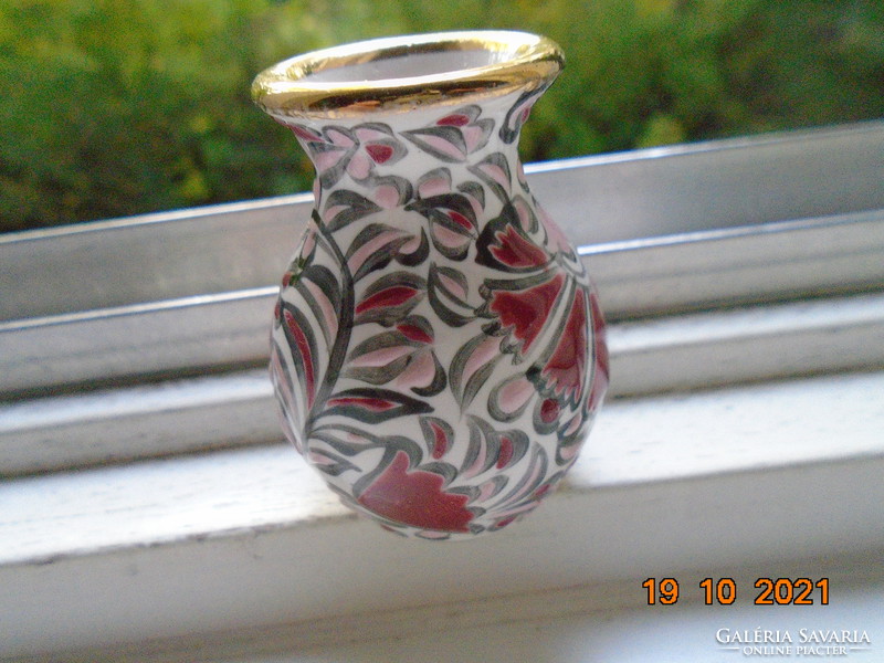 Hand-painted small ceramic vase marked with embossed enamel floral patterns