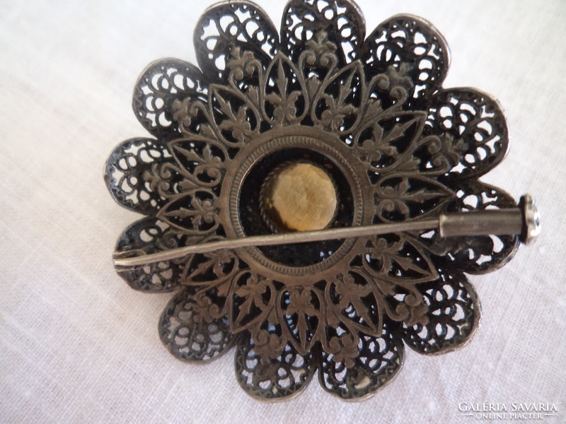 Marked with an old silver filigree brooch.