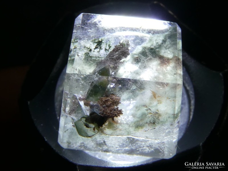 A gemstone overgrown with manganese oxide inclusions polished from natural rock crystal. 10.3 Ct