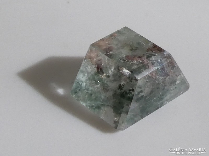 A gemstone overgrown with manganese oxide inclusions polished from natural rock crystal. 10.3 Ct