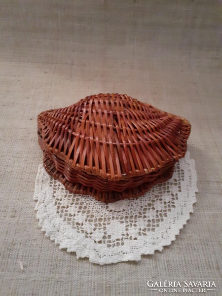 Old sparse small wicker candy storage table decoration with old crochet fishnet tablecloth