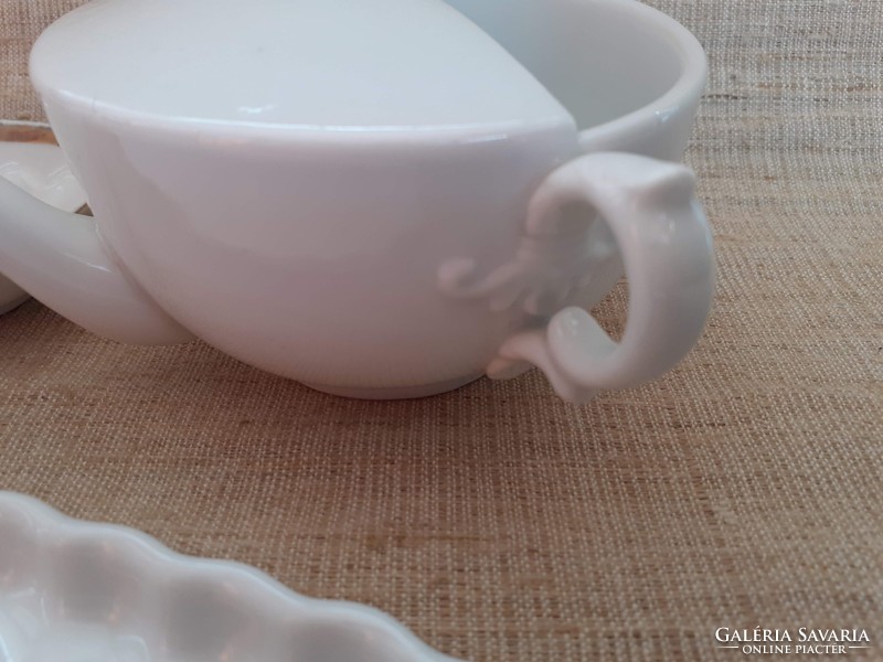 Old white porcelain drinking cup with gilded edge soap dish on porcelain tray in one