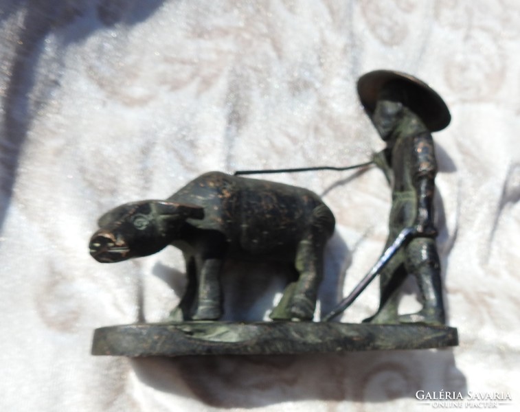 Peasant bronze statue leading an ancient Vietnamese water buffalo xix. Century