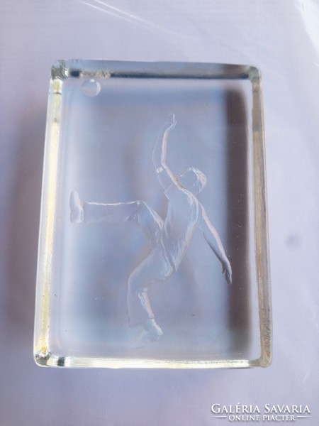 Soccer figurine on glass table.