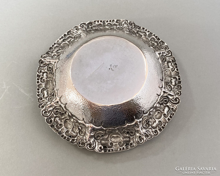 Richly decorated silver serving basket.