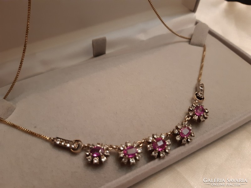 My gold necklace with pink sapphires in the shape of a daisy.
