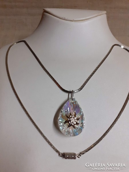 Polished glitter crystal pendant in the middle adorned with alpine weeds on a long special chain