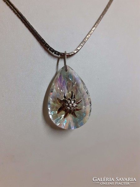 Polished glitter crystal pendant in the middle adorned with alpine weeds on a long special chain