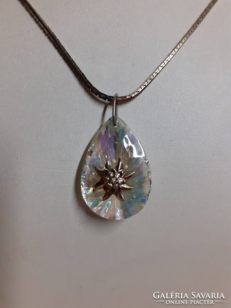 Polished glitter crystal pendant in the middle adorned with alpine weeds on a long special chain