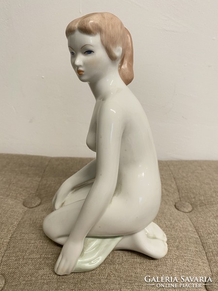 Woman kneeling in aquincum porcelain