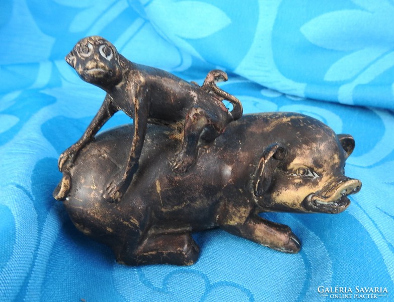 Antique Tibetan bronze statue: monkey on the back of a pig