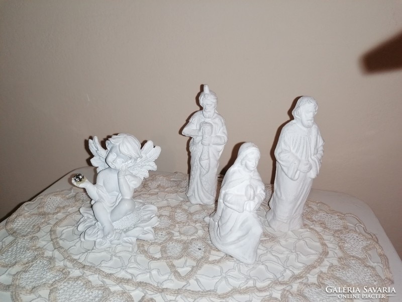 Christmas white decorative figurines under the Christmas tree.