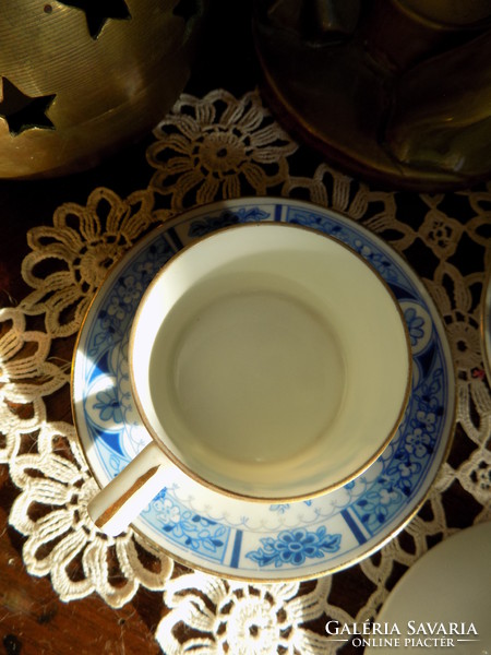 Two small cups with three plates