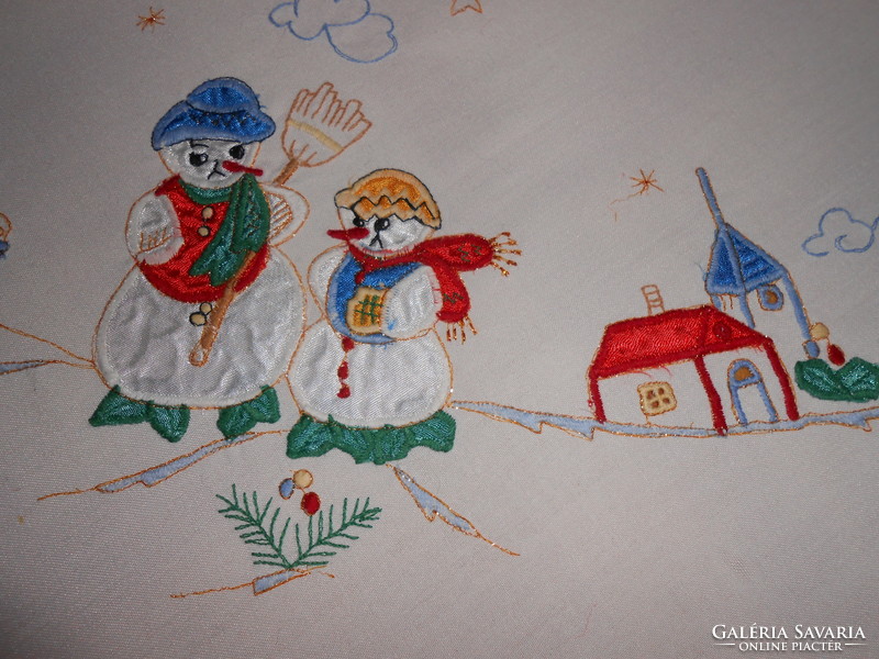 Embroidered tablecloth with snowman.