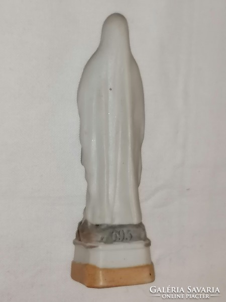 Antique statue of the Virgin Mary of Lourdes.