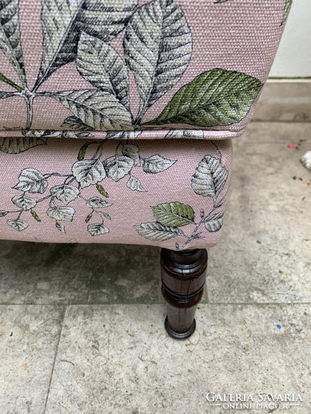Elevated puff or table next to armchair